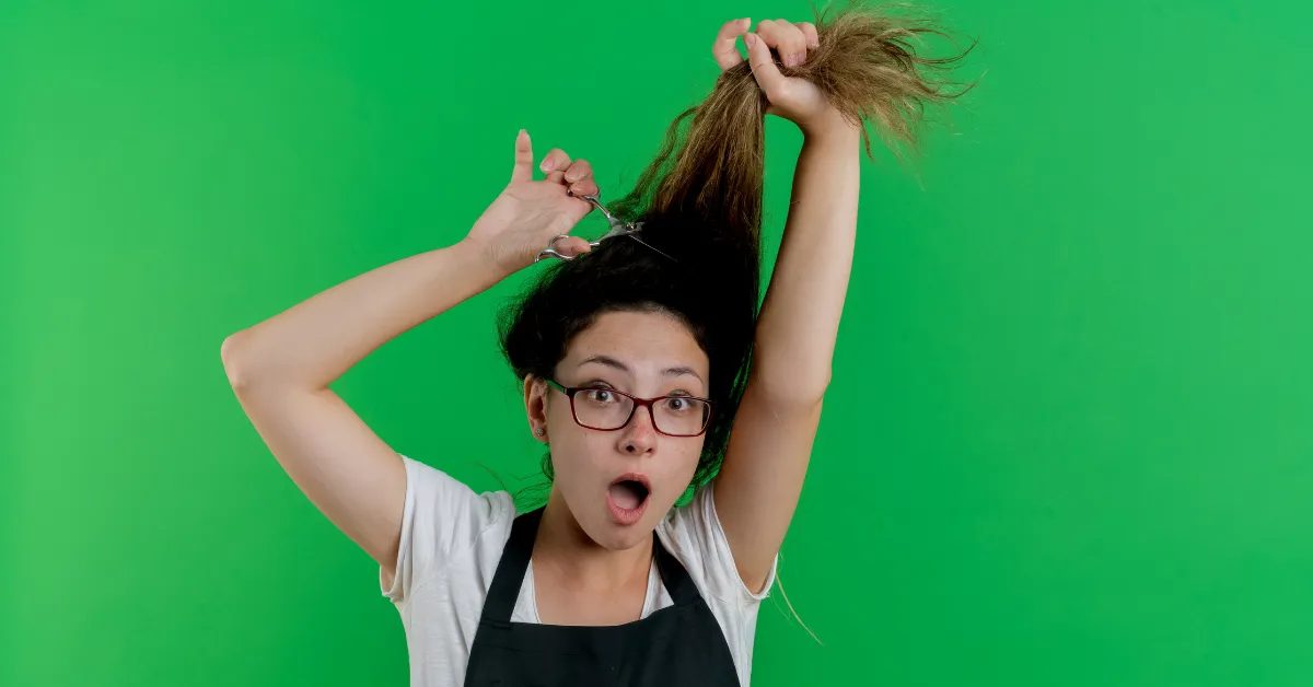 Surprised woman cutting hair on green background, 2 color hair ideas inspiration look